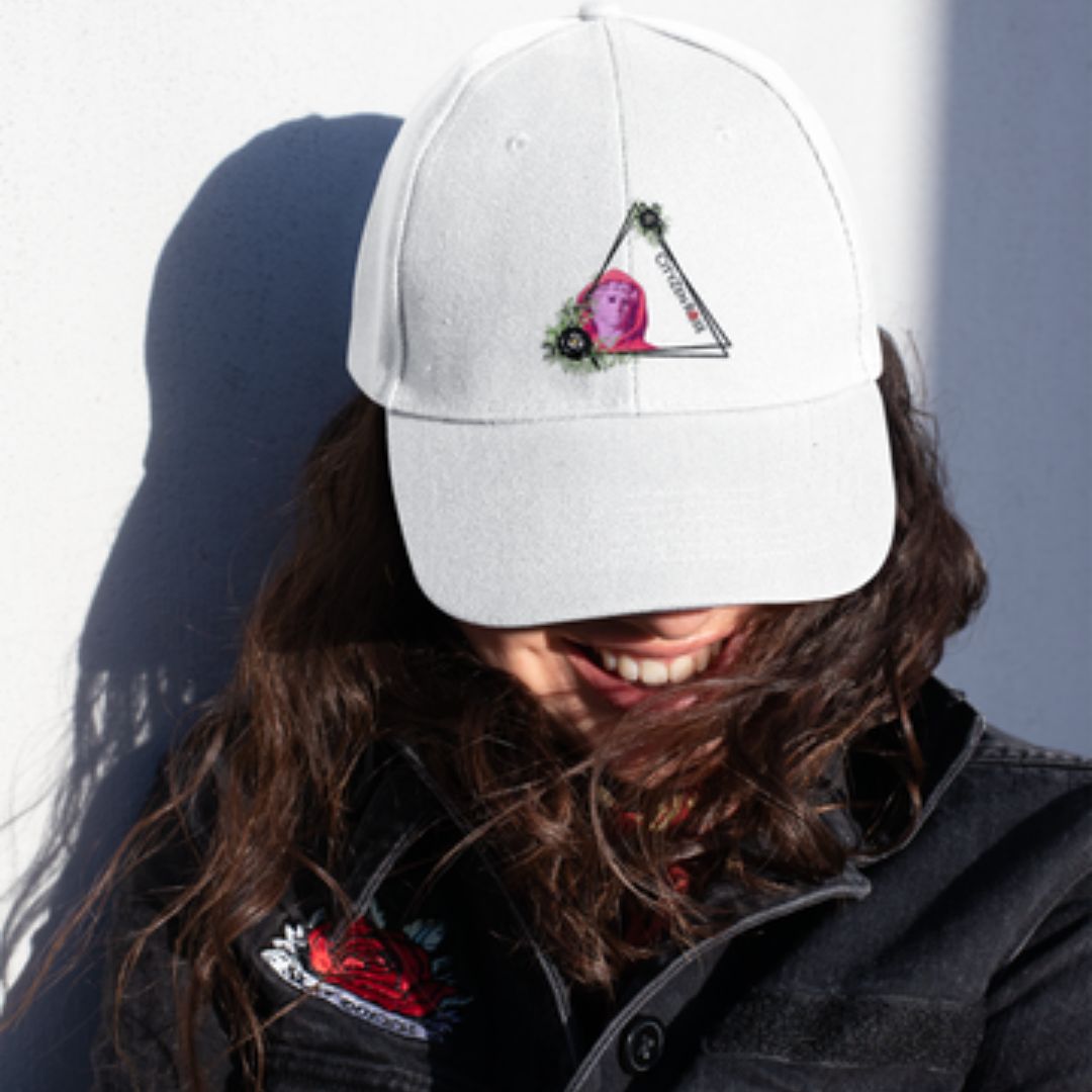 woman wearing a white ball cap with a CityZen styled graphic